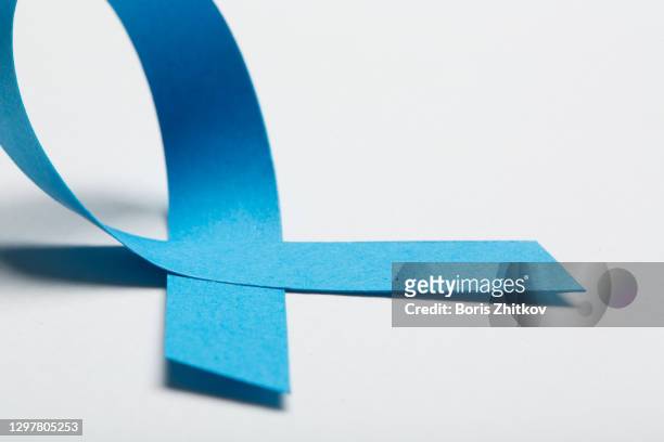 blue awareness ribbon. - childhood cancer stock pictures, royalty-free photos & images