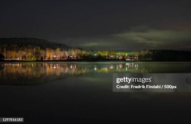 scenic view of lake against sky at night - väder stock pictures, royalty-free photos & images