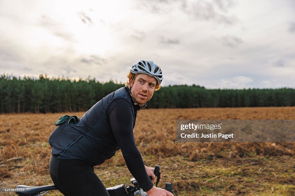 Portrait of Cyclist in forest clearing