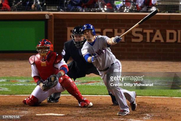Michael Young of the Texas Rangers hits an RBI sacrifice fly ball to take a 3-2 lead in the ninth inning during Game Two of the MLB World Series...