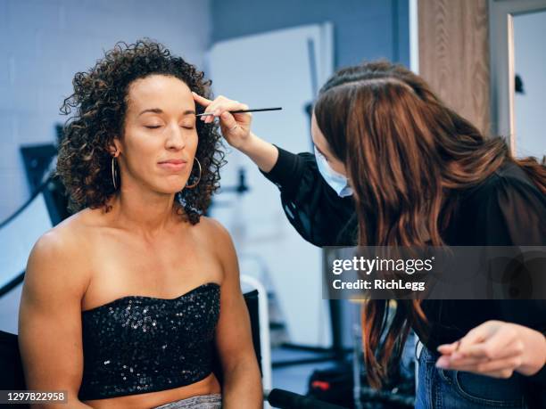 makeup artist at work in a studio - diverse film set stock pictures, royalty-free photos & images