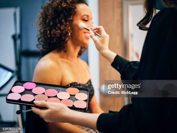 makeup artist at work in a studio - diverse film set stock pictures, royalty-free photos & images