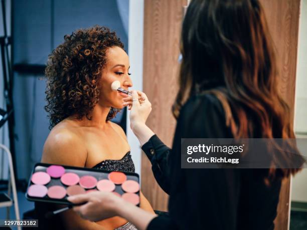 makeup artist at work in a studio - diverse film set stock pictures, royalty-free photos & images