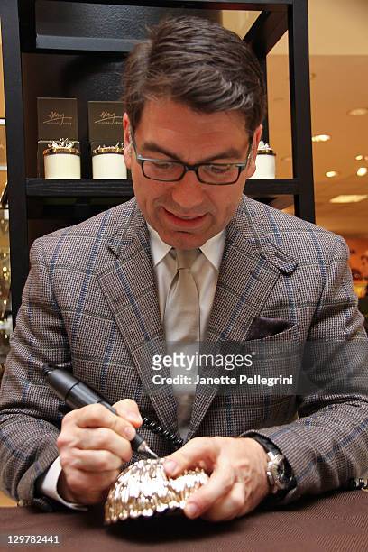 Artisan Designer Michael Aram signs his work at Ready, Set, Pink! event at Bloomingdale's at Roosevelt Field Mall on October 20, 2011 in Garden City,...
