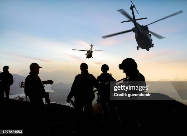 silhouettes of soldiers during military mission at dusk - turkish army stock pictures, royalty-free photos & images