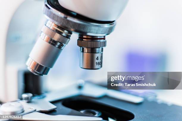 microscope with a slide - microscope lens stock pictures, royalty-free photos & images