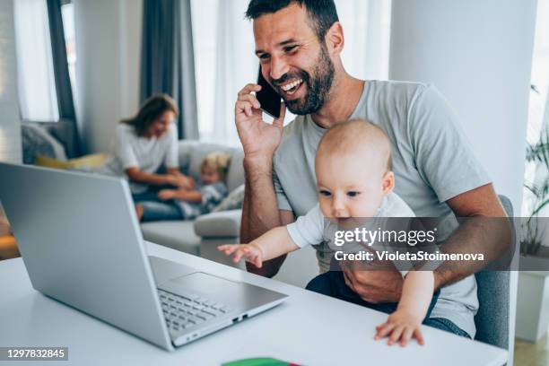 vader en baby die thuis werken. - familie laptop stockfoto's en -beelden