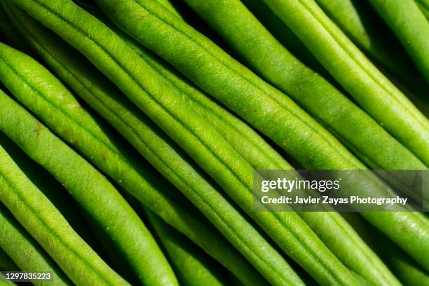 green beans on an old wooden surface - sunny kitchen stock pictures, royalty-free photos & images