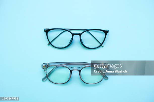 trendy modern minimalistic flat lay with two eyeglasses - blue spectacles stock pictures, royalty-free photos & images