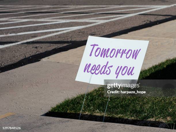 sign that reads "tomorrow needs you" placed by a sidewalk. - suicide stock pictures, royalty-free photos & images