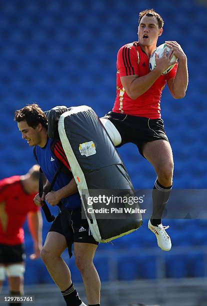 Israel Dagg of the All Blacks catches the ball over the top of Zac Guildford during a New Zealand All Blacks training session at Trusts Stadium on...