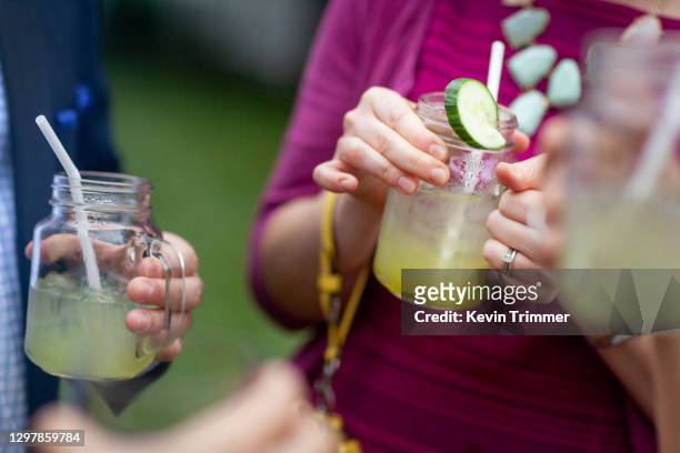 man pouring cocktail into glass at a bar - adult cocktail party background stock-fotos und bilder