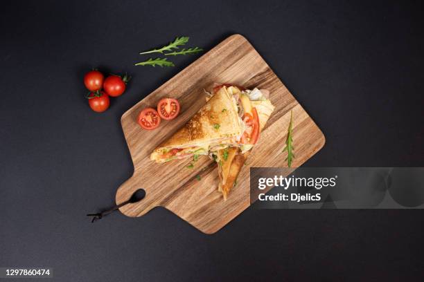 crepes, thin pancakes with ham, cheese, mushrooms and tomatoes. - close up bread roll black backdrop horizontal stock pictures, royalty-free photos & images
