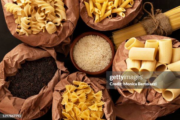 different types of dry pasta and rice in recycling bags - carbs bildbanksfoton och bilder