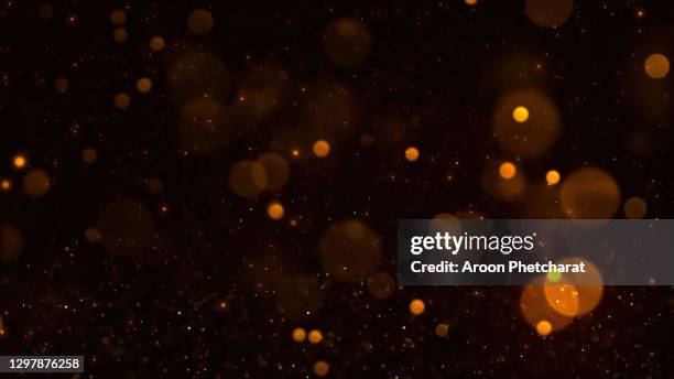 abstract bokeh lights with black background. - goldstrahlen stock-fotos und bilder