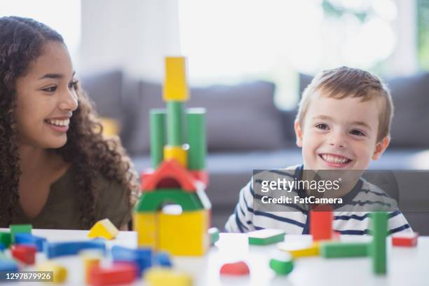 let's build the tallest tower together - nanny stock pictures, royalty-free photos & images