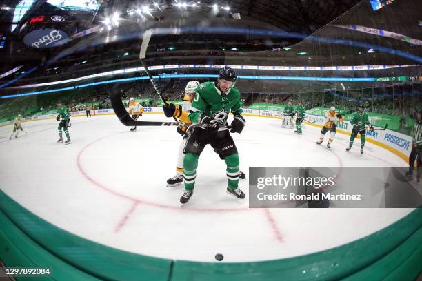 John Klingberg of the Dallas Stars skates for the puck against Yakov Trenin of the Nashville Predators in the third period at American Airlines...