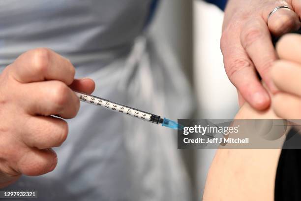 Staff and key workers receive the coronavirus vaccine at the Louisa Jordan Hospital on January 23, 2021 in Glasgow, Scotland. Five thousand health...