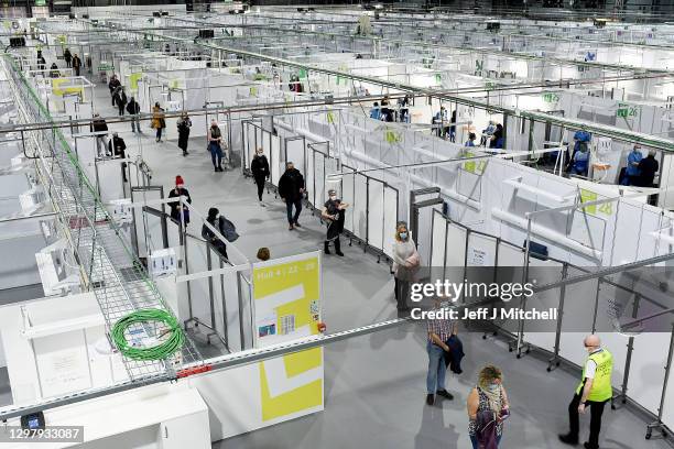 Staff and key workers queue in the Louisa Jordan Hospital before receiving the coronavirus vaccine on January 23, 2021 in Glasgow, Scotland. Five...