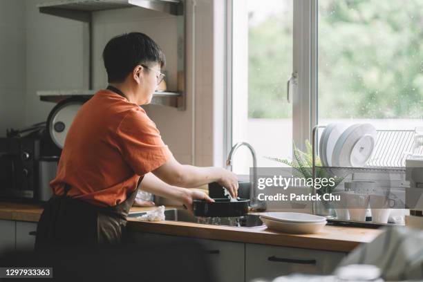 asian chinese mother washing dishes at kitchen - wash the dishes stock pictures, royalty-free photos & images