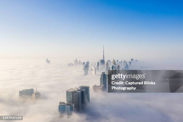 aerial view of dubai frame and skyline covered in dense fog during winter season - torn byggnadskonstruktion bildbanksfoton och bilder