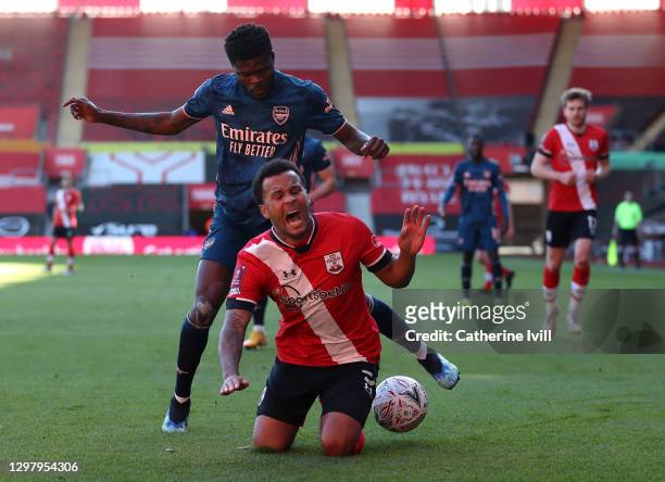 Ryan Bertrand of Southampton is tackled by Thomas Partey of Arsenal during The Emirates FA Cup Fourth Round match between Southampton FC and Arsenal...