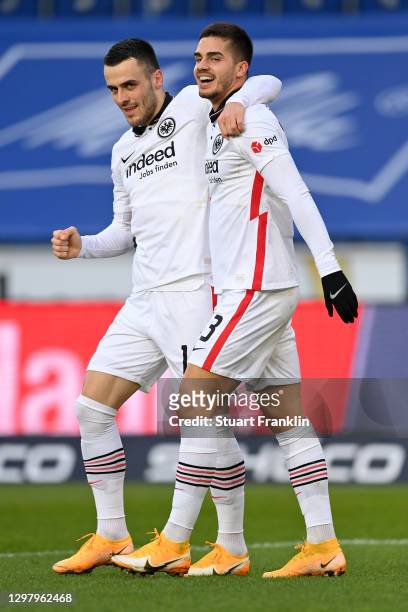 Andre Silva of Eintracht Frankfurt celebrates with teammate Filip Kostic after scoring their team's third goal during the Bundesliga match between...