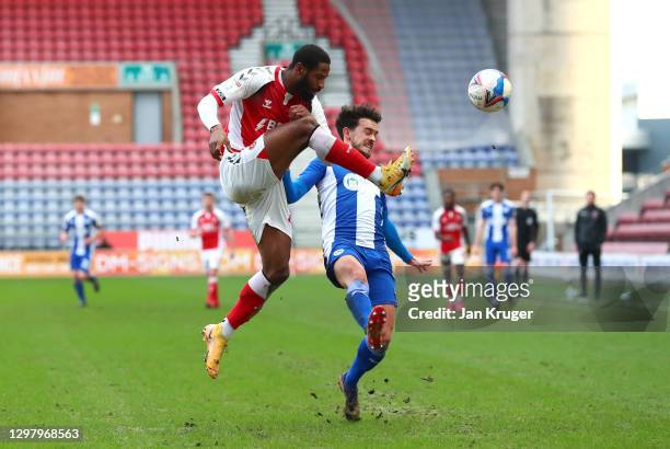 Janoi Donacien of Fleetwood Town clears the ball from Zach Clough of Wigan Athletic during the Sky Bet League One match between Wigan Athletic and...