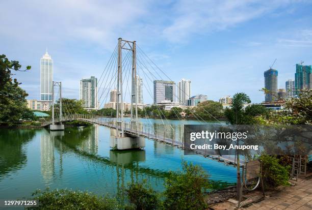 view of colombo cityscape and skyscrapers with a bridge on beira lake a lake in the center of the city. - colombe stock-fotos und bilder