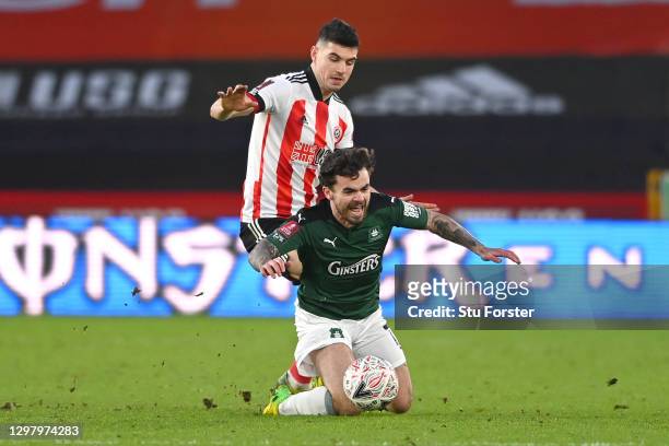Dominic Telford of Plymouth Argyle is fouled by John Egan of Sheffield United during The Emirates FA Cup Fourth Round match between Sheffield United...