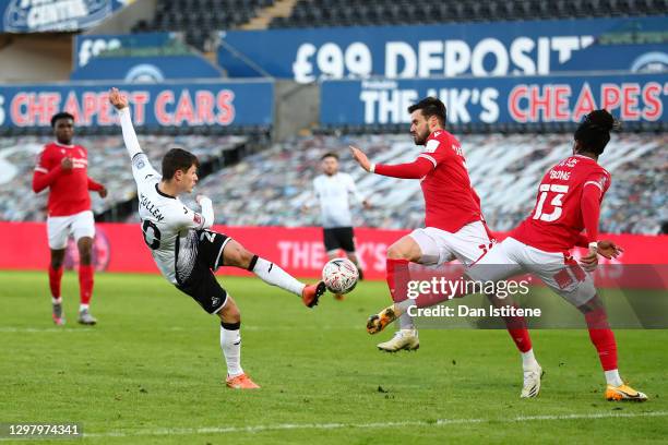 Liam Cullen of Swansea City has his shot blocked by Carl Jenkinson and Gaetan Bong of Nottingham Forest during The Emirates FA Cup Fourth Round match...