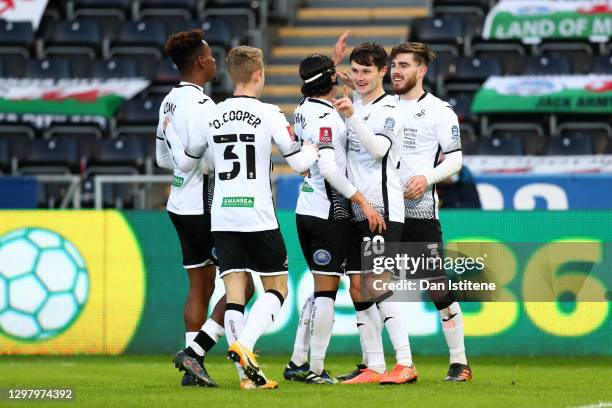 Liam Cullen of Swansea City celebrates with teammates Jamal Lowe, Oli Cooper, Yan Dhanda, and Ryan Manning after scoring his team's fourth goal...