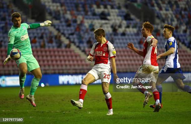 Jamie Jones of Wigan Athletic saves a shot at goal from Harvey Saunders of Fleetwood Town during the Sky Bet League One match between Wigan Athletic...