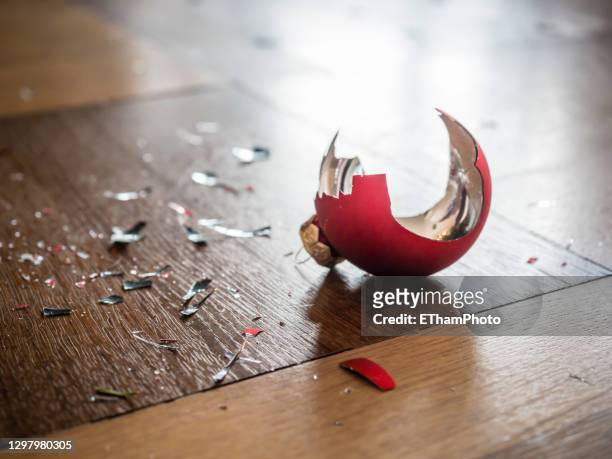shards of a shattered christmas bauble on the floor - domestic violence home stock pictures, royalty-free photos & images