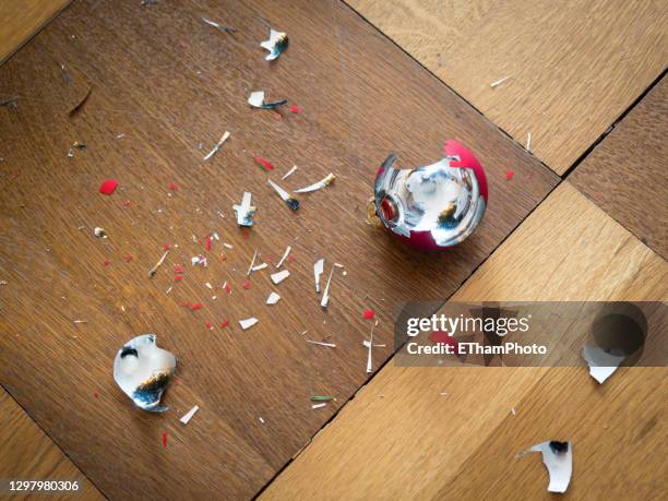shards of a shattered christmas bauble on the floor - ruined christmas stock pictures, royalty-free photos & images