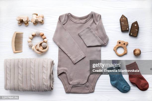 newborn baby clothing, blanket, wooden toys, teether and accessories on white background. - babysaker bildbanksfoton och bilder