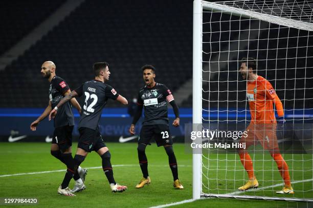 Jiri Pavlenka of Werder Bremen celebrates with teammates Marco Friedl, Theodor Gebre Selassie and Oemer Toprak of Werder Bremen after he saved a...