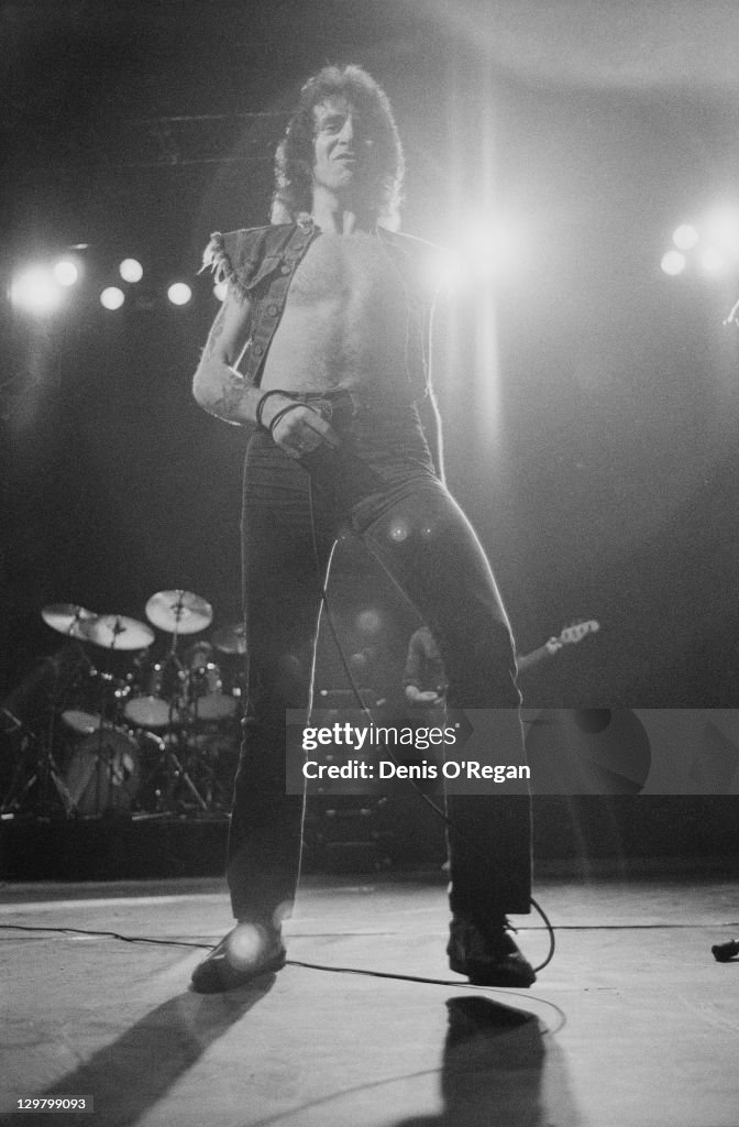 Singer Bon Scott performing with rock group AC/DC at the Gaumont ...