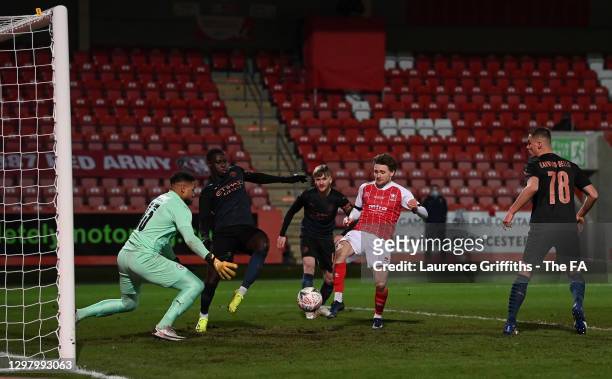 Alfie May of Cheltenham Town scores their team's first goal past Zack Steffen of Manchester City during The Emirates FA Cup Fourth Round match...