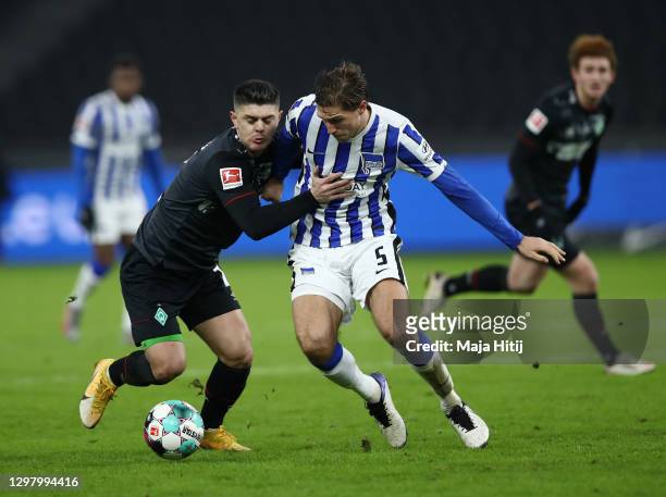 Niklas Stark of Hertha Berlin and Milot Rashica of SV Werder Bremen battle for possession during the Bundesliga match between Hertha BSC and SV...