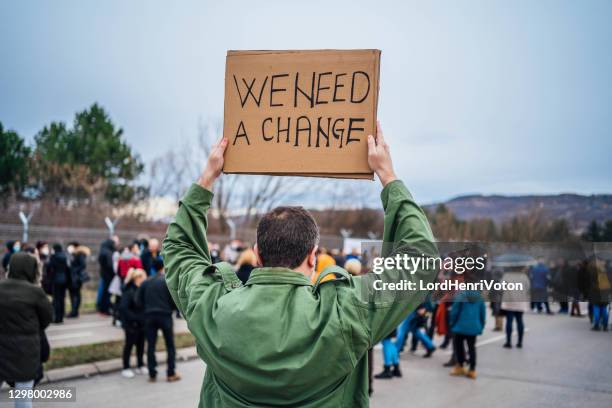 social activists protesting - man placard stock pictures, royalty-free photos & images