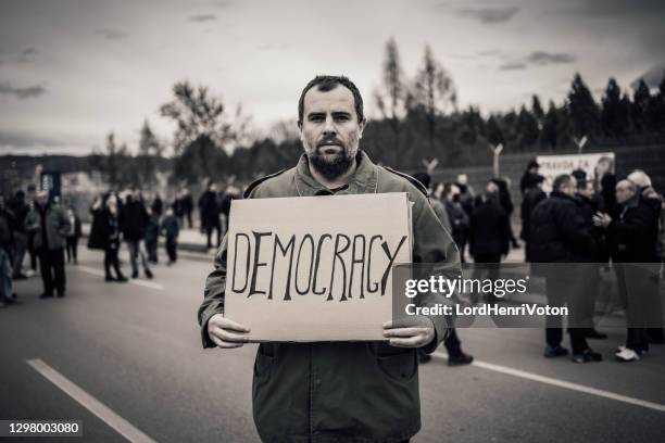 man protesting at the street - revolutionary stock pictures, royalty-free photos & images