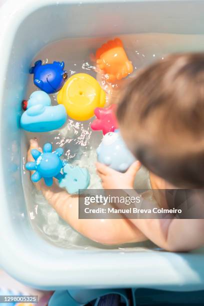 baby in the bathtub - first person perspective stock-fotos und bilder