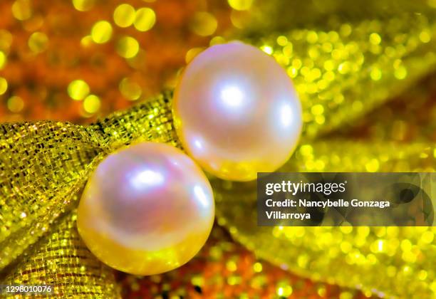 pink- coloured pair of pearl earrings - fashion glamour pearl stock pictures, royalty-free photos & images