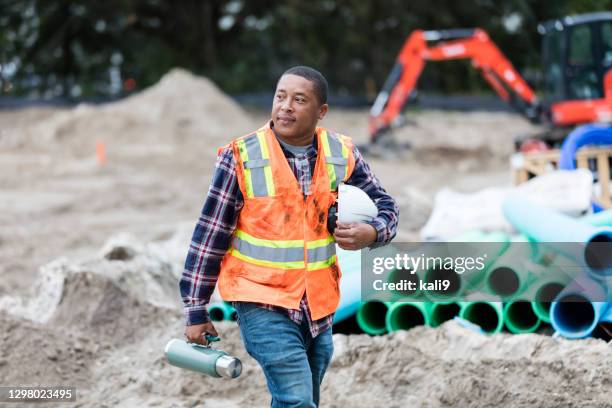 african-american man working at construction site - flask stock pictures, royalty-free photos & images