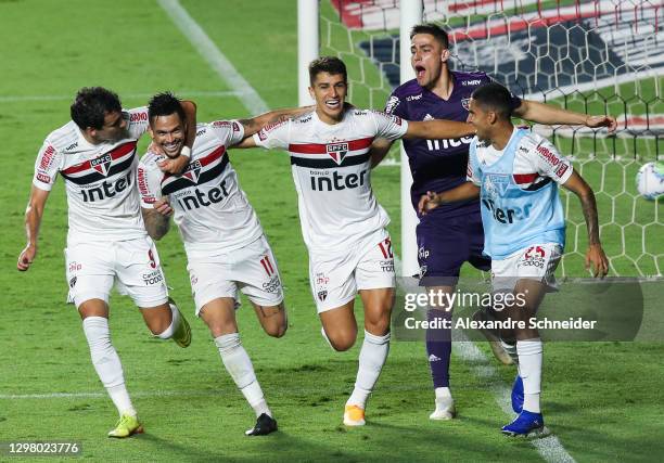 Luciano of Sao Paulo celebrates with his teammates after scoring the first goal of their team during the match against Coritiba as part of of...