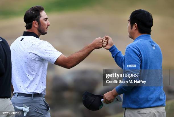 Max Homa fists pumps John Huh after their round on the 18th green during the third round of The American Express tournament on the Stadium course at...