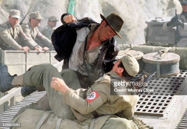 American actor Harrison Ford as the eponymous archaeologist in a scene from the film 'Indiana Jones and the Last Crusade', 1989. Here, he has a...