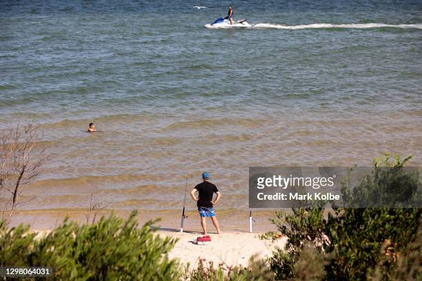 Fisherman watches the water near the Kyeemagh Beach Baths on January 24, 2021 at Botany Bay in Sydney, Australia. The Bureau of Meteorology has...