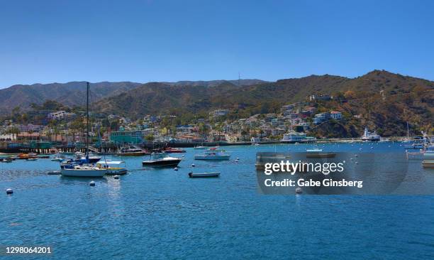 view of avalon bay with avalon in the background - avalon catalina island california stock pictures, royalty-free photos & images